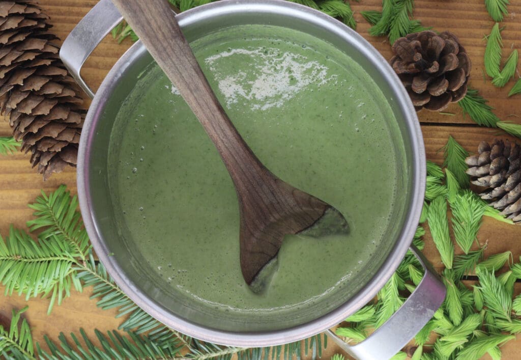 Image of spruce tip cookie mixture in a small sauce pan while adding soaked gelatine leaves.